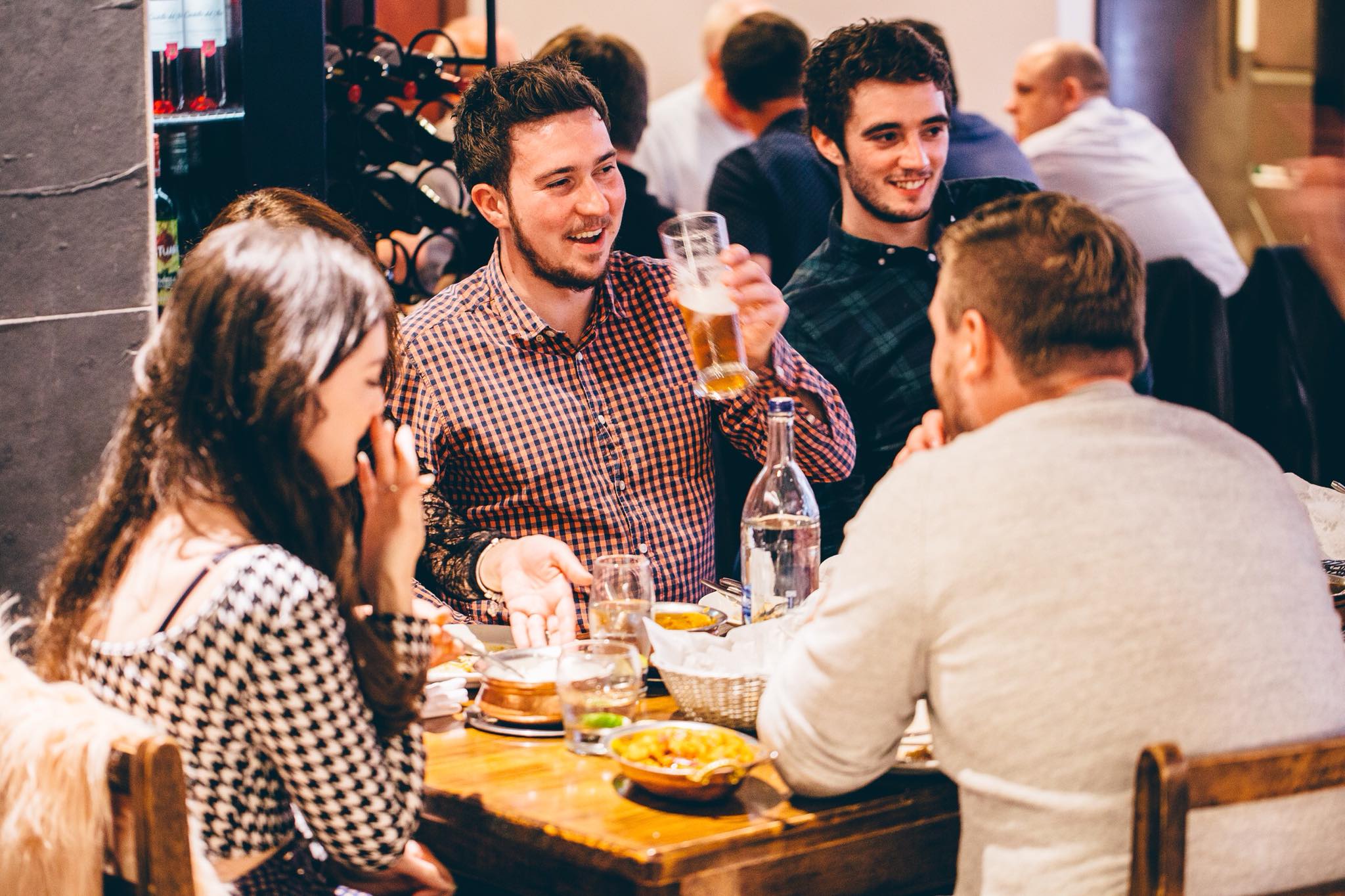 Colleagues laughing in The Dhabba, one of many Indian restaurants Merchant City Glasgow. 