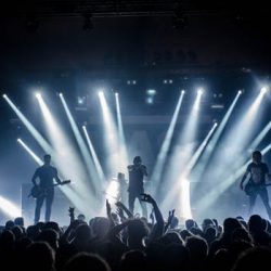 Photo taken from the back of the crowd with a clear view of the stage while one of the best wedding bands perform a showcase.