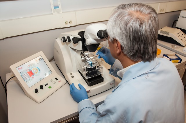 man looking through microscope